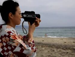 Japanese woman filming with 8mm camera Stock Footage