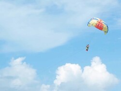 HD: Paraglider Soaring Over The Beach Stock Footage