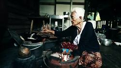 Lifestyle Senior asian woman Sitting a Cooking Food, Slow motion Stock Footage