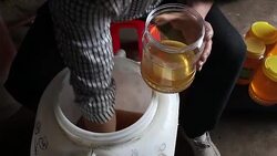 Beekeeper pack honey to small bottles Stock Footage