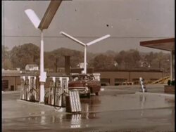 1957 Chevy pulls into Tenneco gas station Stock Footage
