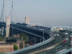 Time lapse, early morning vista with Philadelphia cityscape and traffic crossing The Ben Franklin Bridge. Stock Footage