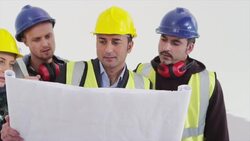 Construction workers examining blueprint Stock Footage