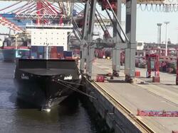 MS Shot of unloading containers in container ship on container terminal with trolley in harbour / Hamburg, Germany Stock Footage