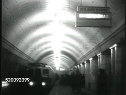 1935: MOSCOW, USSR, SOVIET UNION: WS Subway metro (metpo) station. INT Subway w/ train arriving, people walking on platform, train moving, * LA TU subway car leaving station (dark).  Russia, Communism, lifestyle, improved conditions, propaganda. Instructional Video
