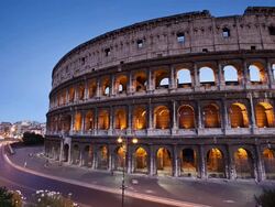 T/L View of Rome's Colosseum or Coliseum and urban traffic at susnet / Rome, Italy Stock Footage
