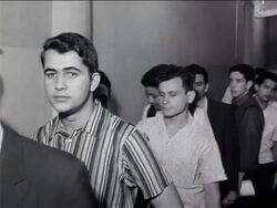 B/W 1960s line of men standing in line waiting to enlist in military for Vietnam War / newsreel Stock Footage