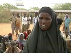 UN officer speaking to refugees with loudspeaker Stock Footage