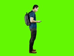 Young asian man using mobile phone on green background. Stock Footage