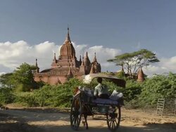 MS Shot of Horse carriage driving past Pagoda / Bagan, Mandalay Division, Myanmar Stock Footage