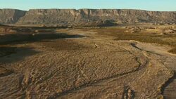 Aerial shot of the dry Terlingua Creek with Santa Elena Canyon, Big Bend National Park. Stock Footage
