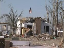 MS Tornado damage - Destroyed home flying American flag, sunny, USA Stock Footage