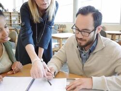 Group of diverse adults studying for continuing education college course in library with bright windows Stock Footage
