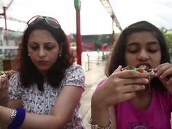 Mother and daughter eating pizza Stock Footage