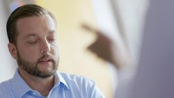 Small business owner listens to employee's concerns in team meeting Stock Footage