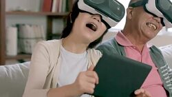 Couple playing with virtual reality headsets Stock Footage