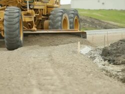 Grader Smoothing Gravel Surface for Asphalt Road Stock Footage
