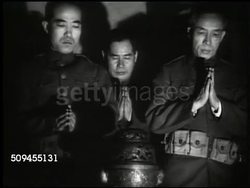 1936: FEBRUARY INCIDENT REPRISAL: Lantern (no light) hanging outside. Tori gate. EXT Building. Japanese soldiers praying. Japanese male w/ tanto (short sword) from sheath. Idol standing by wall. Japanese male face on table. Seppuku, Hara-kiri. Instructional Video