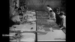1947: LOMBARDY GARMENT MASS PRODUCTION: INT WS Men laying cloth on long table. HA WS Men cutting patterns into cloth. MS Tracing pattern. VS Men using cloth cutters to cut patterns. NYC Instructional Video