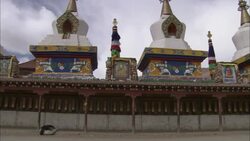 Tourists pass an ornate temple in Tibet. Stock Footage