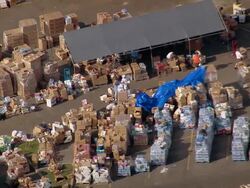 September 13, 2005 aerial medium shot relief workers sorting boxes at relief camp / Slidell, Louisiana Stock Footage