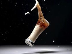 MS SLO MO Glass of beer splashing and falling gainst black background / Vieux Pont, Normandy, France Stock Footage