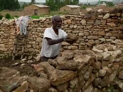 Afar men building a stone enclosure Stock Footage