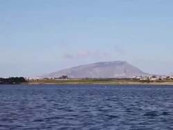 Mozia (Motya), sailnig in the open sea to island of Mozia, Erice mountain in the background Stock Footage