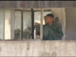 Inmates Look Out From Bullet Ridden Prison News Clip