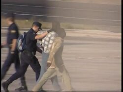 Immigrants put on a plane escorted by the police News Clip