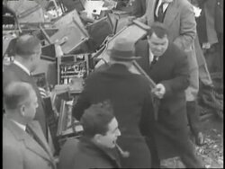 New York City Mayor Fiorello LaGuardia helps throw a slot machine off a barge. News Clip