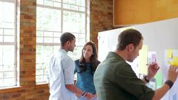 Designers at board in office Stock Footage