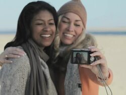 Female friends photographing themselves Stock Footage