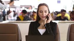 HD:Businesswoman working by using mobile phone at airport. Stock Footage