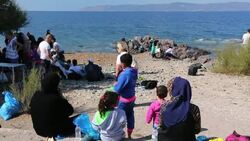 Syrian migrants fleeing the war and escaping to Europe, landing on the Greek island of Lesvos on the north coast at Efthalou and are being helped by a charity aid station. Up to 4,000 migrants a day are landing on the island and overwhelming the authoritie Stock Footage