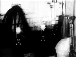 B/W 1933 close up machine putting caps on bottles of liquor/beer in distillery / repeal of Prohibition Stock Footage