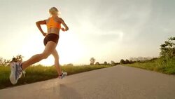 SLO MO TS Female marathon runner running at sunset Stock Footage