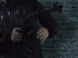 man in leather jacket with machine gun HD Stock Footage