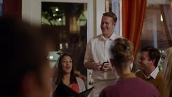 Waiter chats with dinner party in downtown restaurant Stock Footage