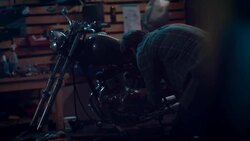 Man in motorcycle workshop building a bike Stock Footage