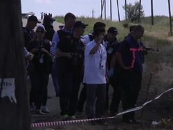 OSCE workers inspecting MH17 crash site News Clip