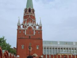 Pan down from tower on Kremlin wall to tourist walking Stock Footage