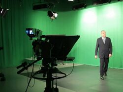 Mature male TV presenter walking out of studio Stock Footage