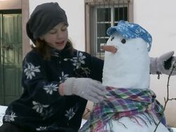 MS Girl completing process of making snowman / Saarburg, Rhineland-Palatinate, Germany Stock Footage