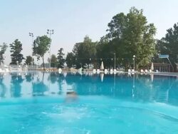 HD CRANE: Swimming In The Pool Stock Footage