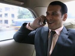 Businessman talking on mobile phone in a car, Mumbai, Maharashtra, India Stock Footage