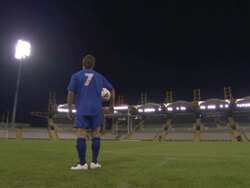 LA WS Soccer player standing and looking around empty stadium at night / Sheffield, England, UK Stock Footage