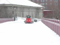 MS Small plow cruising down snowy bridge toward car / Minneapolis, Minnesota, United States Stock Footage