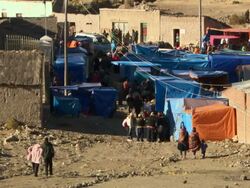 Wide of people arriving at market stalls in Cala Cala, Bolivia during spring festival Stock Footage