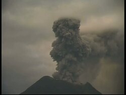 CU Mount Tunguragua, of grey smoke and ash cloud billowing quickly upwards from crater, zoom out to WA, Ecuador Stock Footage